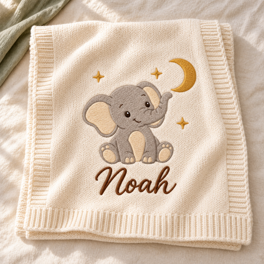 Digital design preview: cream knit blanket with a seated elephant, crescent moon, three stars and the example embroidered name Noah.
