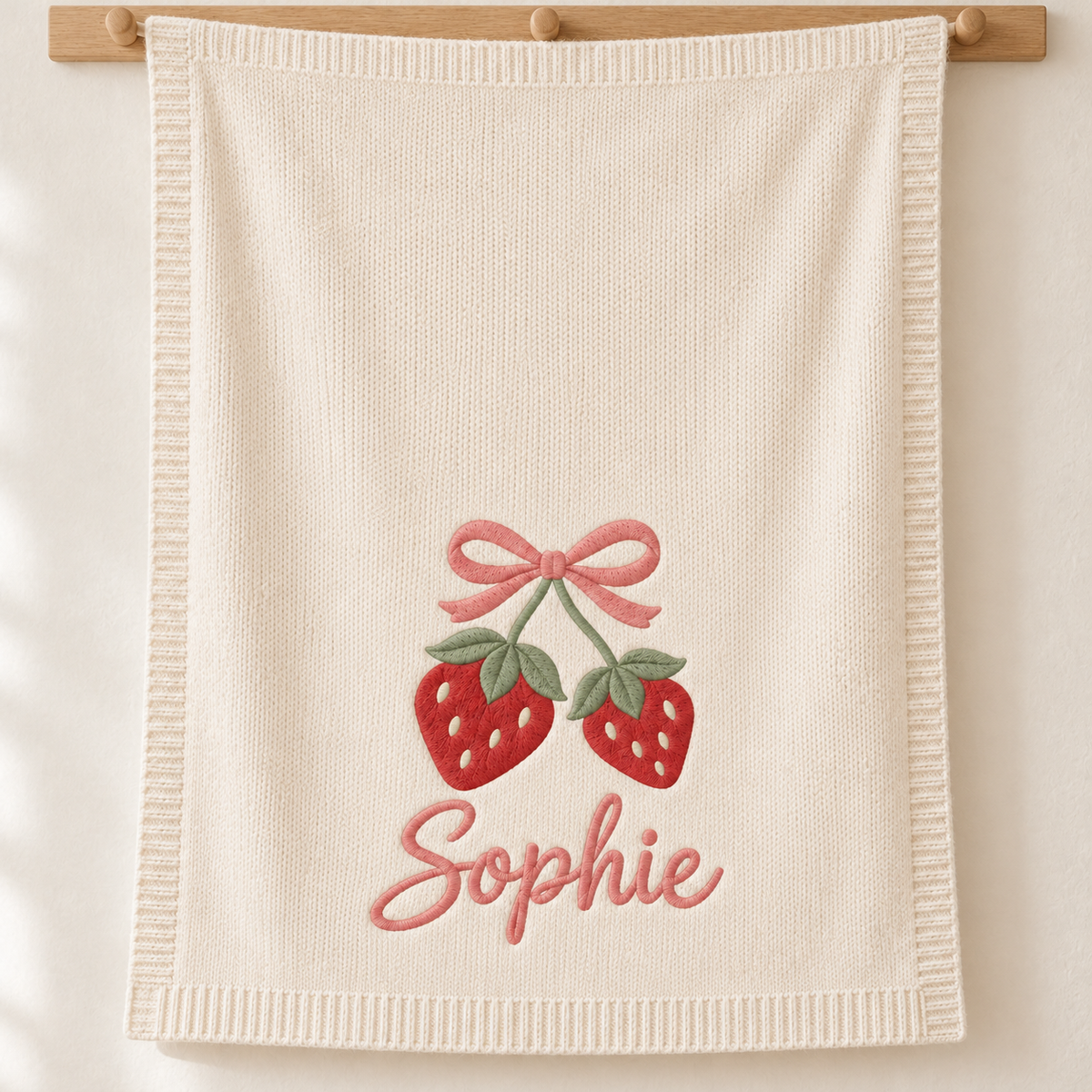 Strawberry & Bow — digital styling preview with an example embroidered name