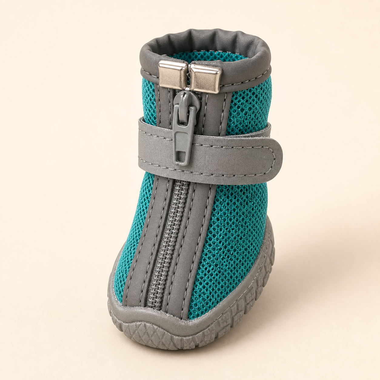 Teal mesh CityStep dog boot on a warm white background