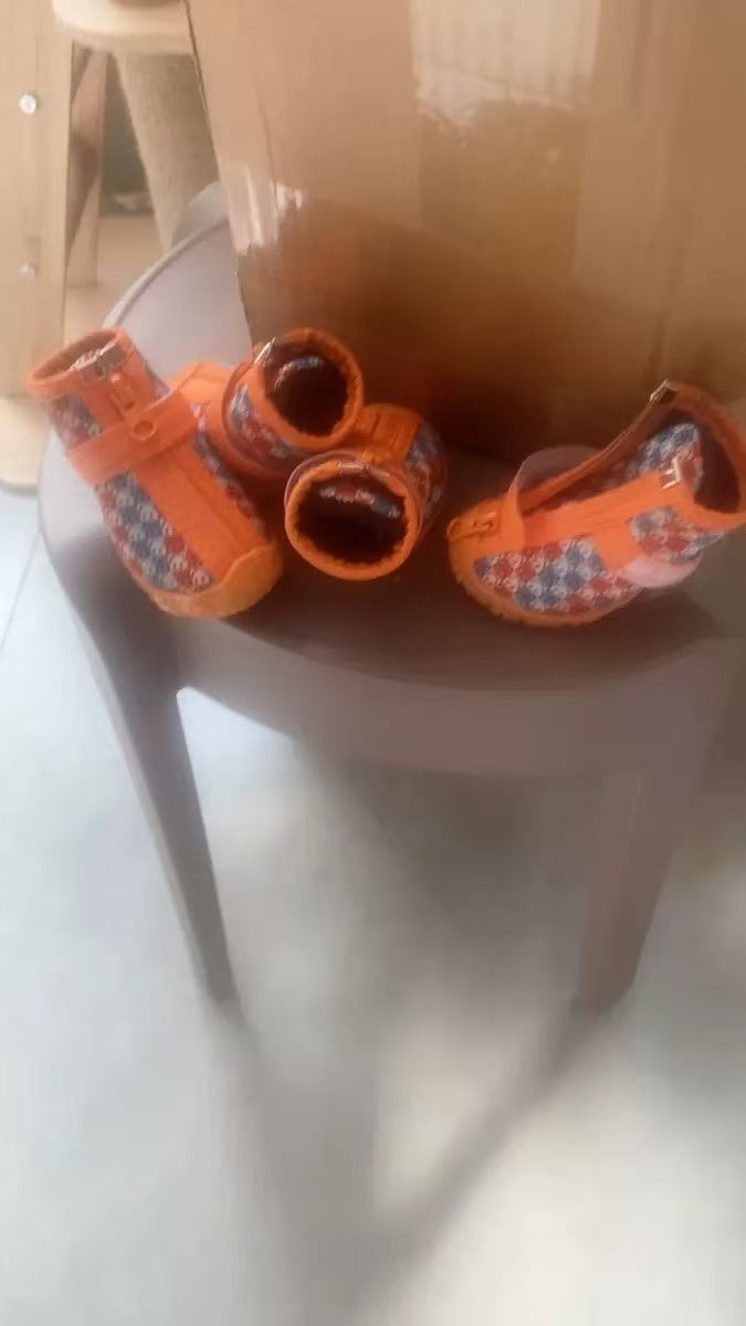 Four orange CozyVale dog boots